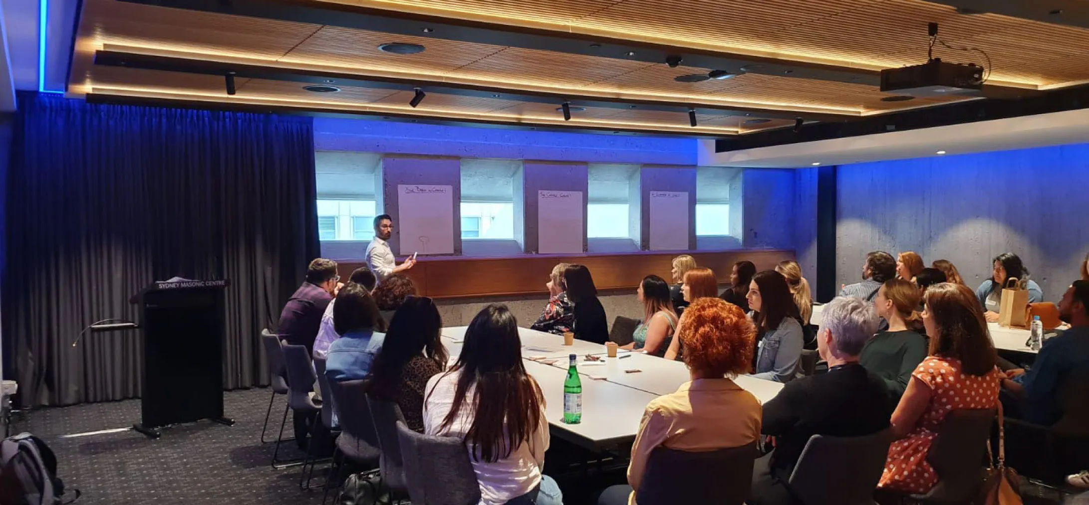 People having a meeting at a boardboard.