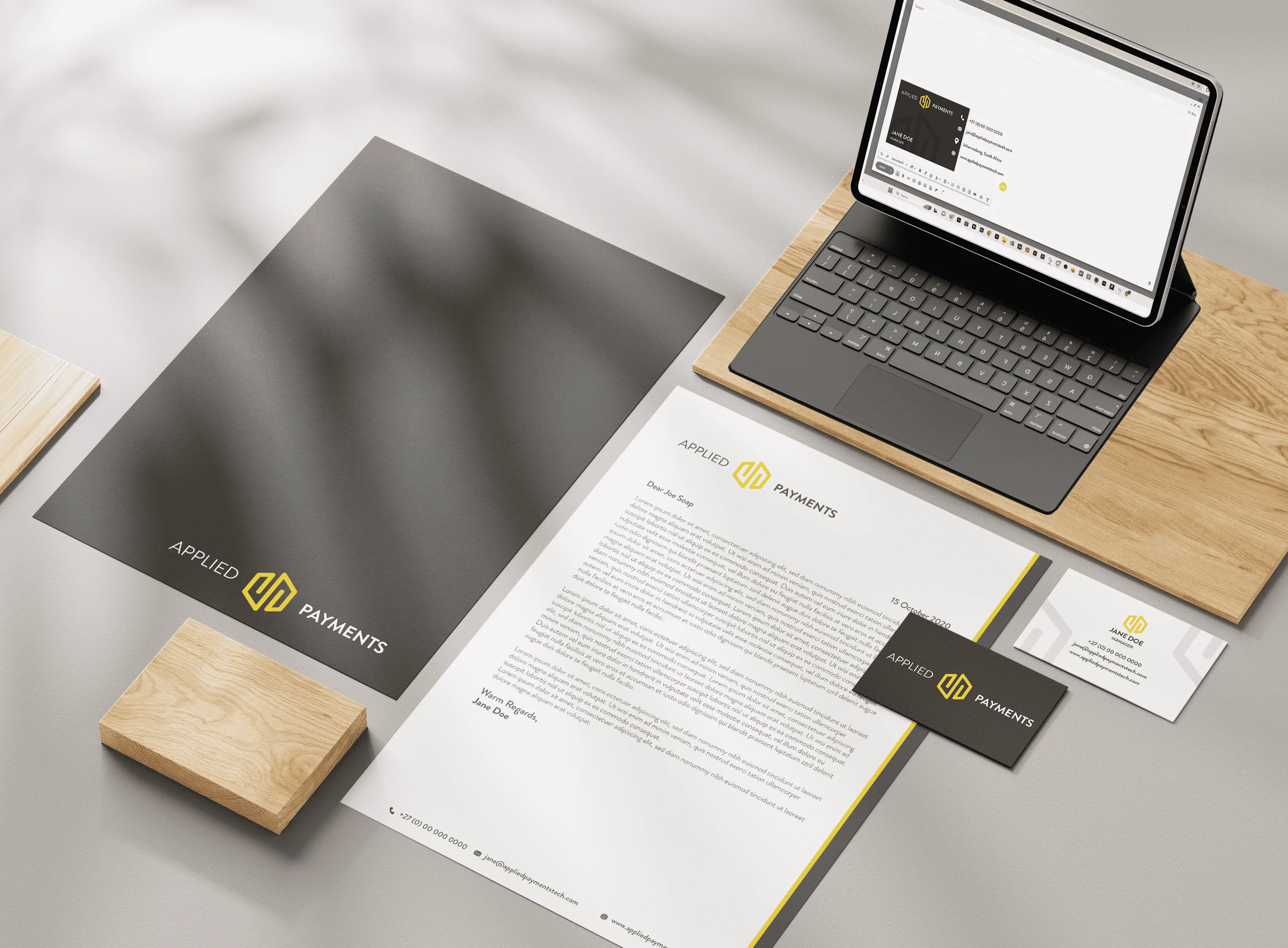 Mock up of business folder, letterhead, business card and email signature for Applied Payments.