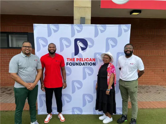 The Pelican Foundation team in front of their custom designed wall banner.