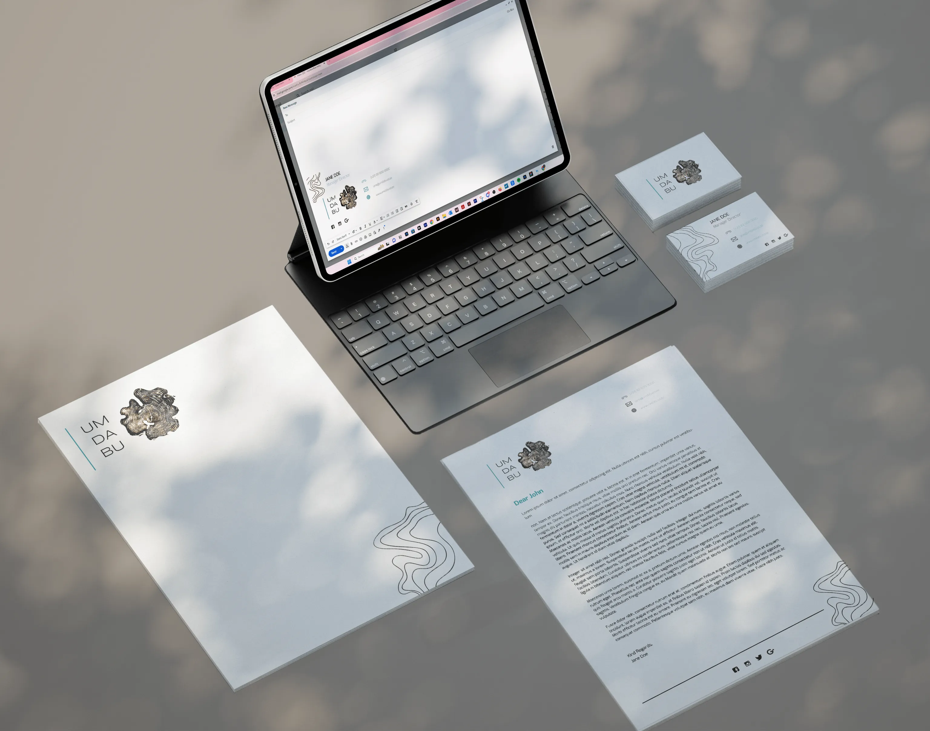 Mock up of business folder, letterhead, business card and email signature for Umdabu.